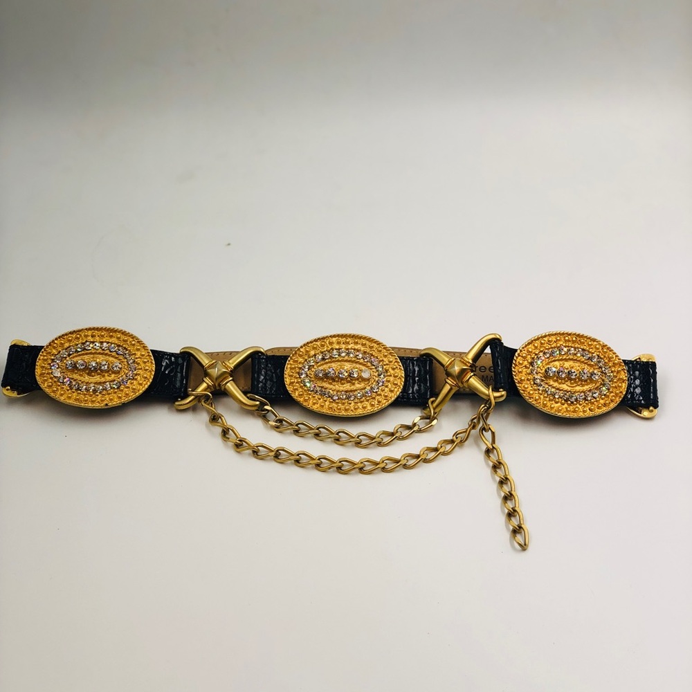 Streets Ahead black leather belt features ornate goldtone oval crystal medallion
